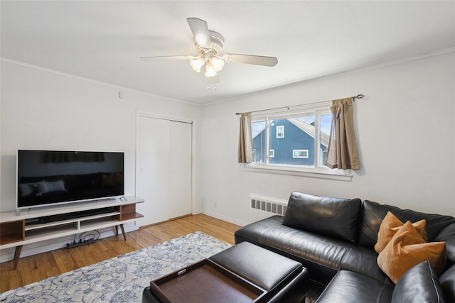 24 Southwood Ln, North Babylon, NY 11703 - living room featuring radiator, baseboards, wood finished floors, ceiling fan, and crown molding