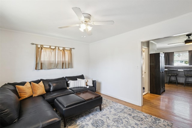 24 Southwood Ln, North Babylon, NY 11703 - living area featuring light wood-type flooring, crown molding, baseboards, and ceiling fan