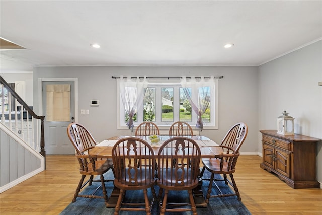 24 Southwood Ln, North Babylon, NY 11703 - dining space featuring light wood-style flooring, baseboards, stairs, and crown molding