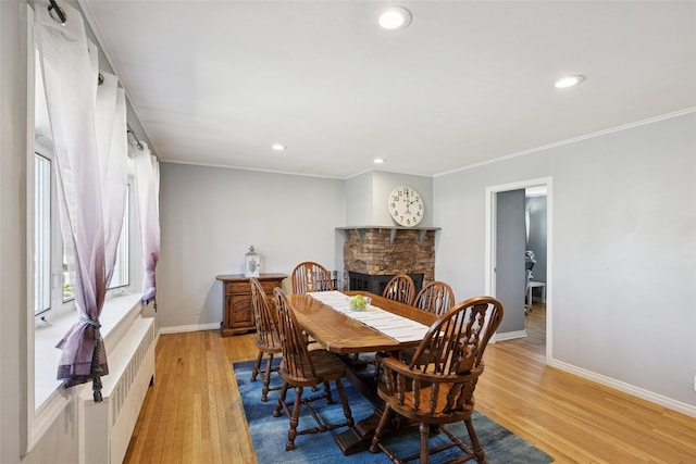 24 Southwood Ln, North Babylon, NY 11703 - dining area with recessed lighting, radiator heating unit, light wood-style floors, crown molding, and baseboards