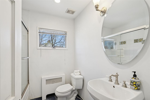 24 Southwood Ln, North Babylon, NY 11703 - bathroom featuring radiator, a shower with door, visible vents, toilet, and a sink