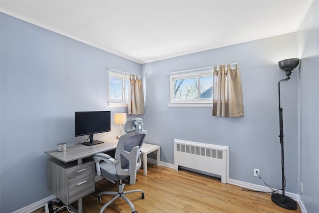 24 Southwood Ln, North Babylon, NY 11703 - home office featuring crown molding, baseboards, radiator heating unit, and wood finished floors