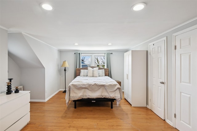 24 Southwood Ln, North Babylon, NY 11703 - bedroom with light wood finished floors and ornamental molding