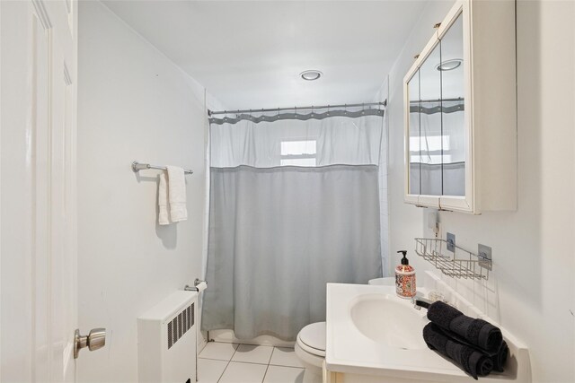 24 Southwood Ln, North Babylon, NY 11703 - bathroom featuring radiator heating unit, tile patterned floors, vanity, a shower with curtain, and toilet