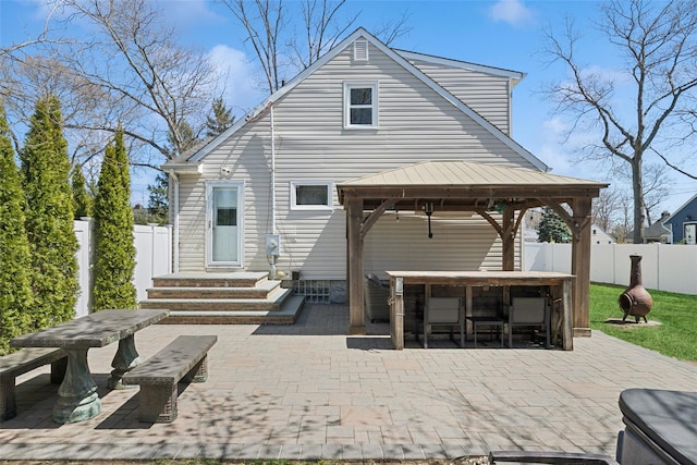 24 Southwood Ln, North Babylon, NY 11703 - back of house featuring a gazebo, outdoor dry bar, a fenced backyard, and a patio