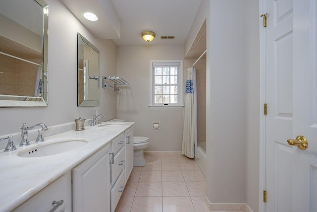bathroom featuring a sink, visible vents, toilet, and baseboards