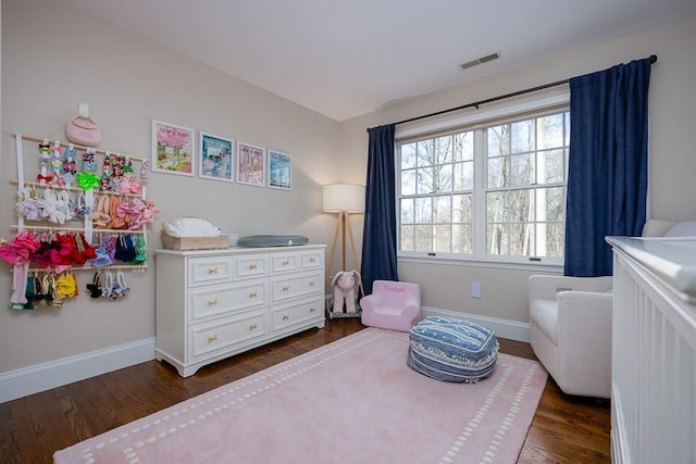 bedroom with dark wood-type flooring, visible vents, and baseboards