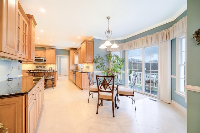 dining area with ornamental molding, visible vents, and plenty of natural light