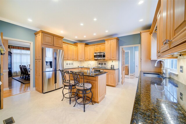 kitchen with stainless steel appliances, visible vents, a sink, and crown molding