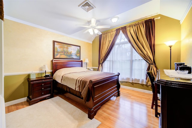 bedroom with lofted ceiling, baseboards, visible vents, and light wood-style floors