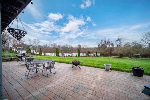 view of patio / terrace with a fire pit and a water view