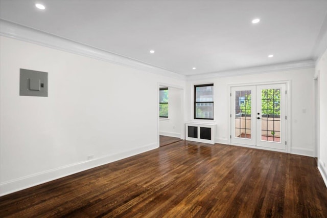 unfurnished living room featuring wood finished floors, ornamental molding, french doors, and electric panel