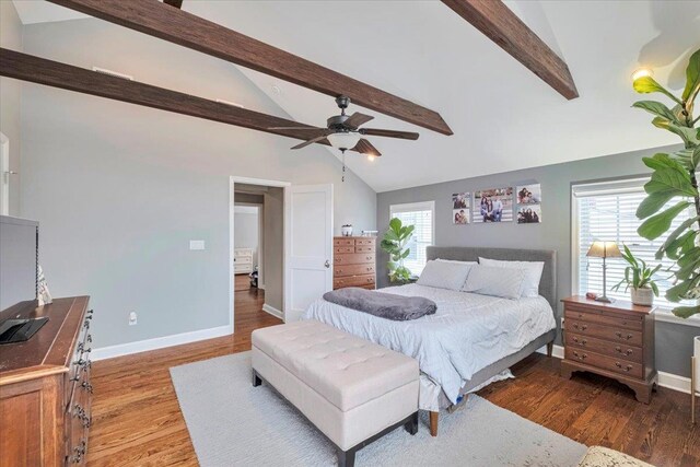 bedroom with baseboards, vaulted ceiling with beams, ceiling fan, and light wood-style flooring