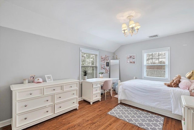 bedroom with an inviting chandelier, vaulted ceiling, multiple windows, and visible vents