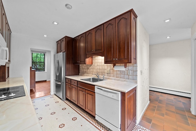 341 Furnace Dock Rd Unit 5, Cortlandt Manor, NY 10567 - kitchen with white dishwasher, baseboard heating, freestanding refrigerator, a sink, and black electric cooktop