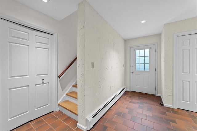 341 Furnace Dock Rd Unit 5, Cortlandt Manor, NY 10567 - entryway with baseboard heating, baseboards, stairs, and a textured wall