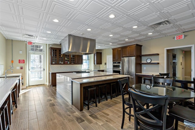 341 Furnace Dock Rd Unit 5, Cortlandt Manor, NY 10567 - kitchen with appliances with stainless steel finishes, ventilation hood, a spacious island, an ornate ceiling, and plenty of natural light