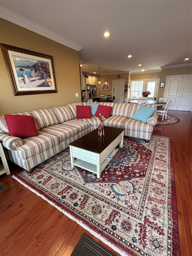 living room with ornamental molding, recessed lighting, and wood finished floors