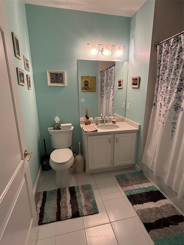 bathroom featuring toilet, tile patterned floors, vanity, and shower / bath combo with shower curtain