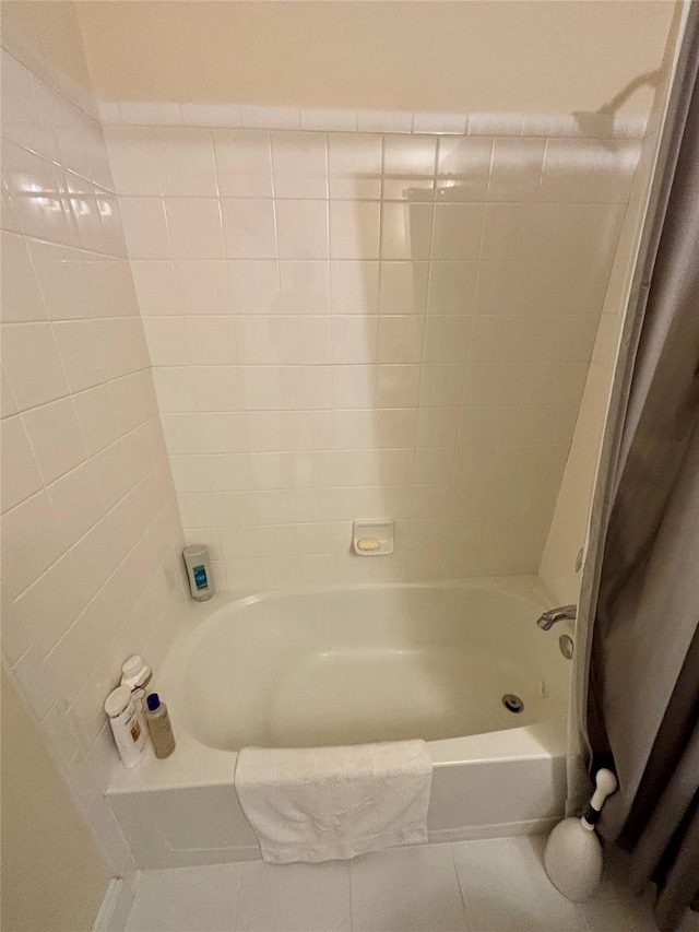 bathroom featuring tile patterned flooring and shower / tub combination