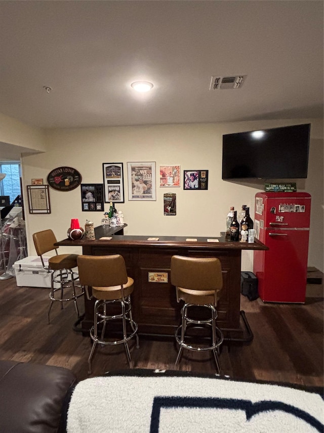 bar featuring dark wood-type flooring, visible vents, a dry bar, and recessed lighting