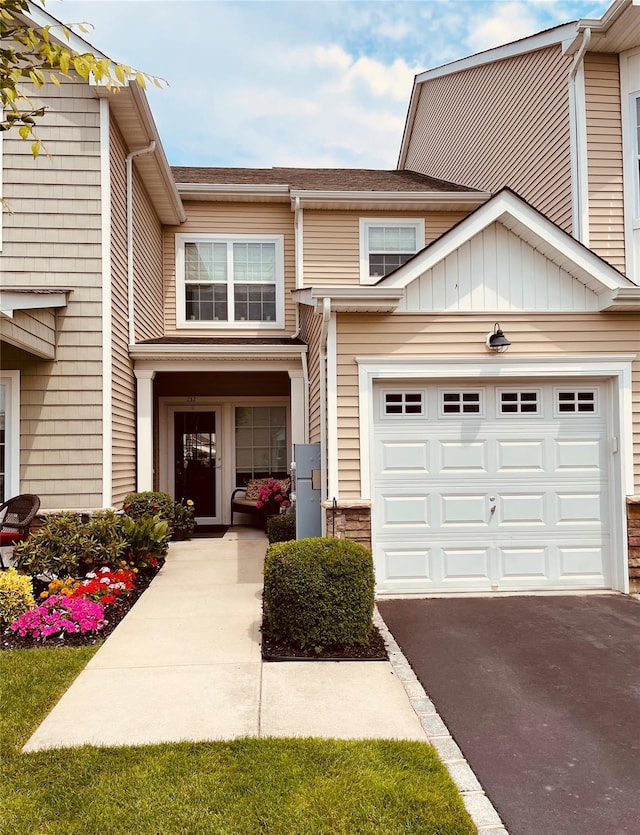 view of property featuring a garage and driveway