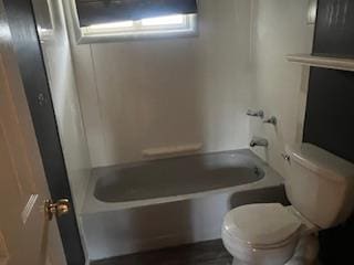 bathroom featuring toilet and shower / bathtub combination