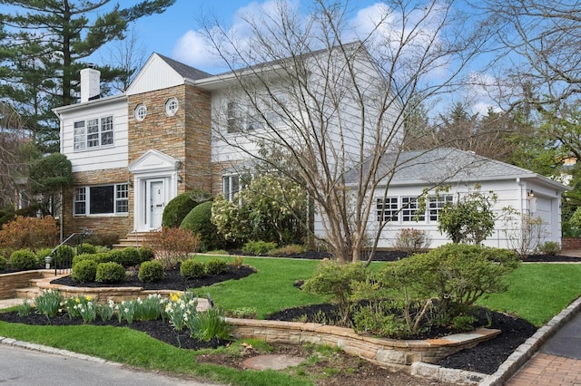 270 Bayberry Dr, Hewlett Harbor, NY 11557 - view of front of house with a chimney, a front lawn, stone siding, and entry steps