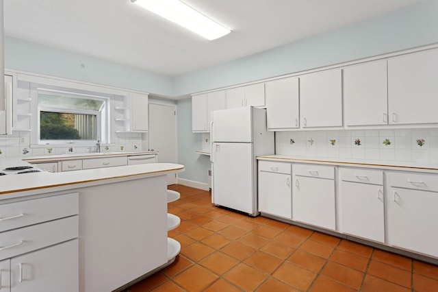 270 Bayberry Dr, Hewlett Harbor, NY 11557 - kitchen with open shelves, light countertops, backsplash, white cabinetry, and freestanding refrigerator