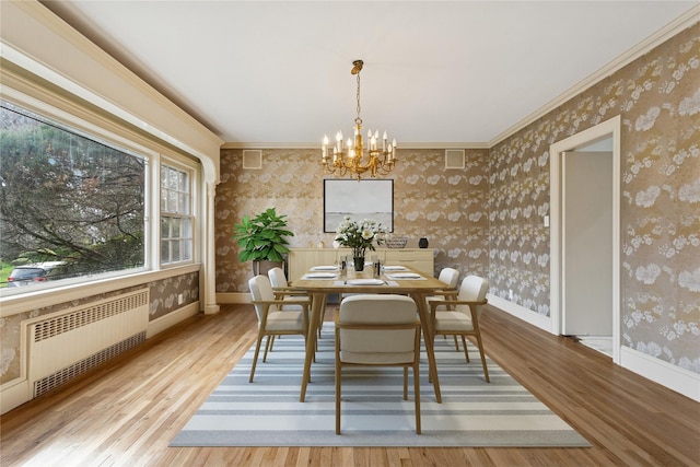 270 Bayberry Dr, Hewlett Harbor, NY 11557 - dining area with radiator, an inviting chandelier, wood finished floors, and wallpapered walls