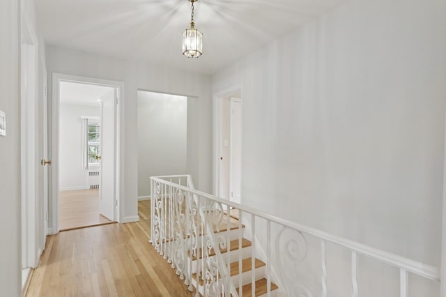 270 Bayberry Dr, Hewlett Harbor, NY 11557 - corridor featuring radiator heating unit, light wood-style flooring, baseboards, and an upstairs landing