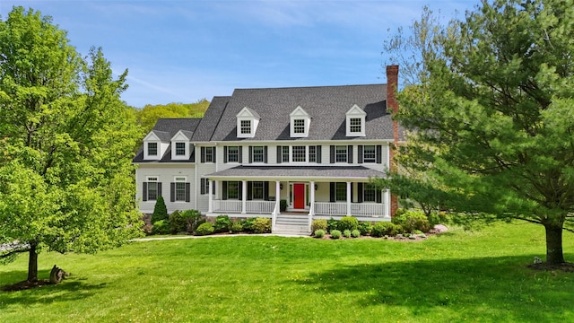 view of front of property featuring a porch, a front yard, and a chimney