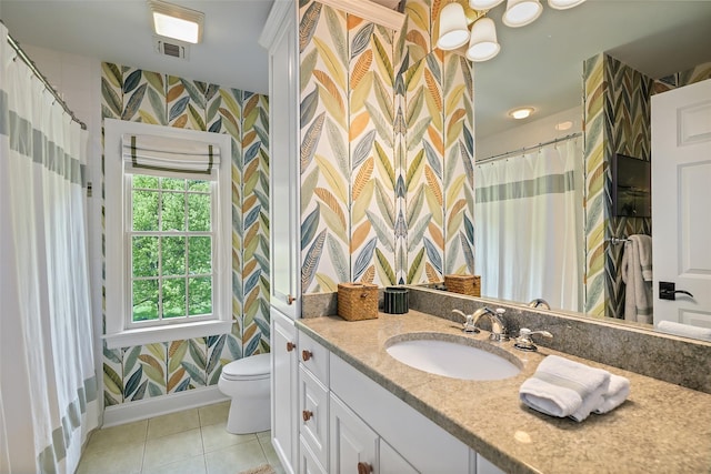 bathroom with wallpapered walls, baseboards, toilet, tile patterned floors, and vanity