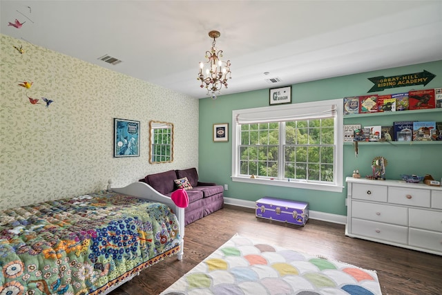 bedroom featuring wallpapered walls, a chandelier, wood finished floors, and baseboards