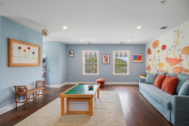 recreation room featuring baseboards, wood finished floors, and recessed lighting