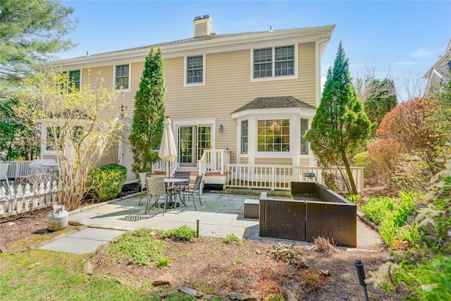 8 Alder Way, Armonk, NY 10504 - rear view of house featuring outdoor lounge area, fence, a chimney, and a patio area