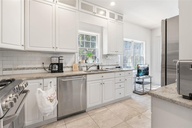 8 Alder Way, Armonk, NY 10504 - kitchen with white cabinetry, appliances with stainless steel finishes, and tasteful backsplash