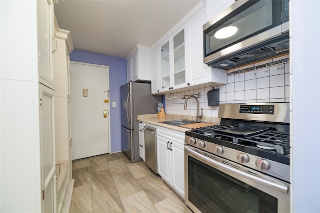 2241 Palmer Ave Unit 3A, New Rochelle, NY 10801 - kitchen featuring stainless steel appliances, a sink, light countertops, and white cabinetry