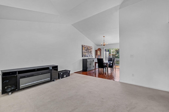 13 Iris Cir, Beacon, NY 12508 - carpeted living room featuring an inviting chandelier, baseboards, and lofted ceiling