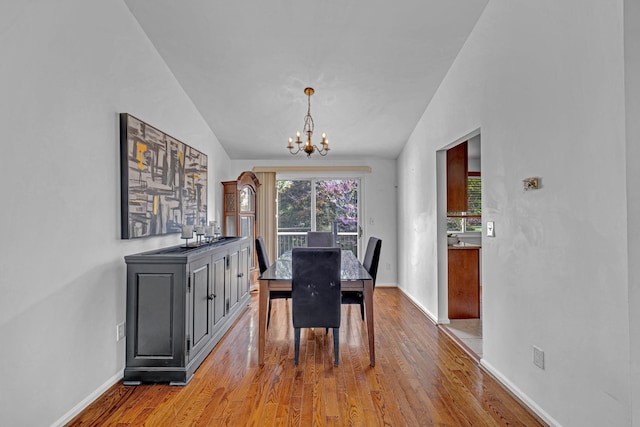 13 Iris Cir, Beacon, NY 12508 - dining room with wood finished floors, baseboards, a chandelier, and lofted ceiling
