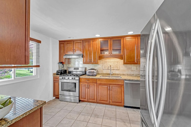 13 Iris Cir, Beacon, NY 12508 - kitchen featuring backsplash, appliances with stainless steel finishes, brown cabinets, a sink, and under cabinet range hood