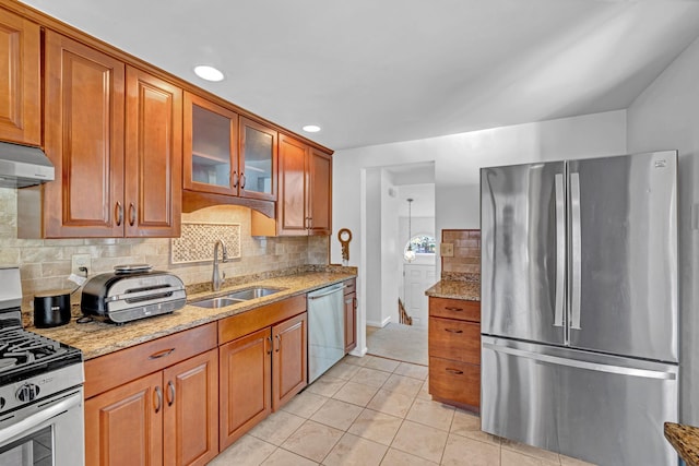 13 Iris Cir, Beacon, NY 12508 - kitchen featuring decorative backsplash, appliances with stainless steel finishes, light stone countertops, a sink, and light tile patterned flooring
