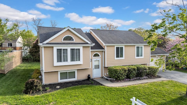13 Iris Cir, Beacon, NY 12508 - raised ranch featuring a shingled roof, fence, and a front yard