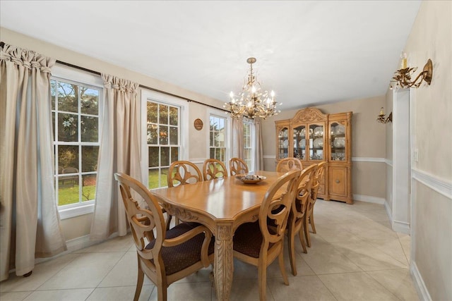 dining space with light tile patterned flooring, plenty of natural light, and a notable chandelier