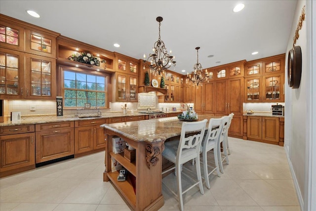 kitchen with open shelves, brown cabinetry, recessed lighting, and a notable chandelier