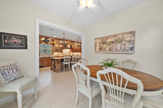 dining room with light tile patterned flooring and ceiling fan with notable chandelier