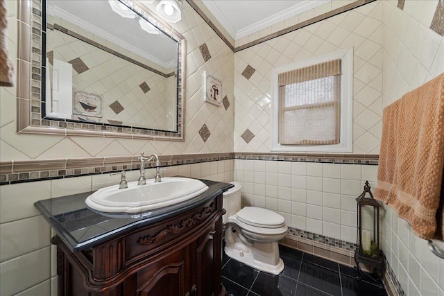 bathroom featuring crown molding, tile patterned floors, vanity, tile walls, and toilet