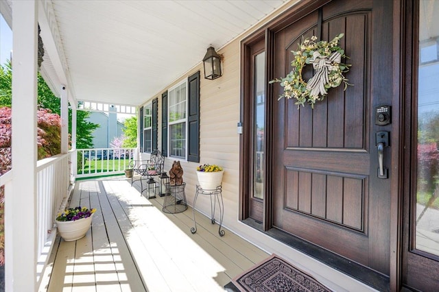 view of exterior entry featuring a porch