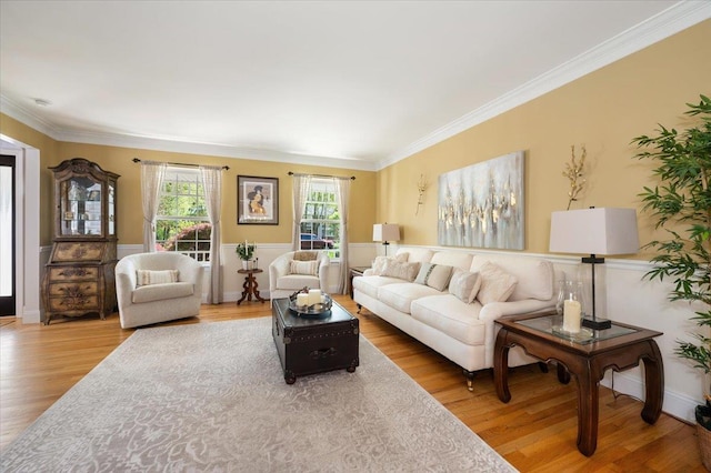 living room with ornamental molding and wood finished floors