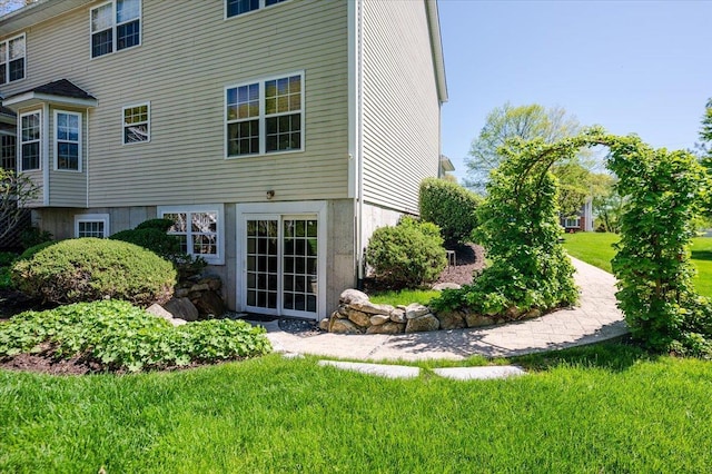 back of property featuring a yard